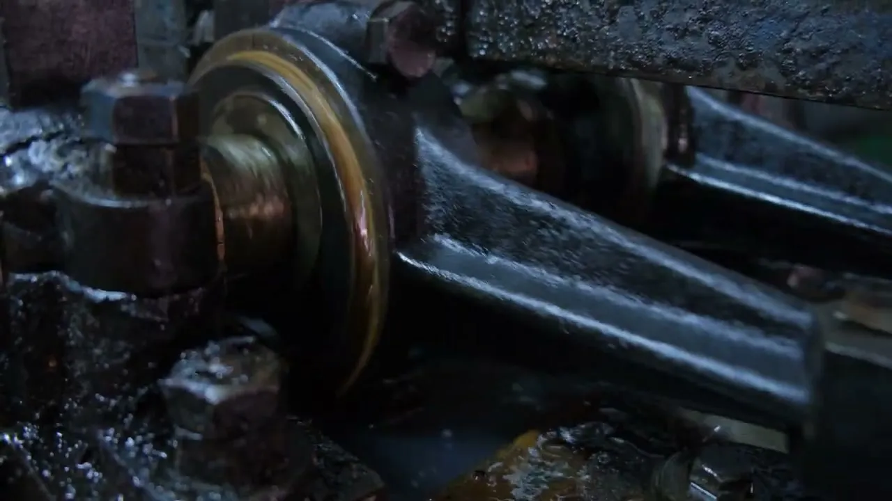 Oil, gold and black, running from the mechanism of the press.